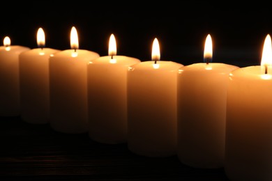 Burning candles on dark background. Memory day