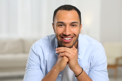 Photo of Portrait of smiling African American man at home