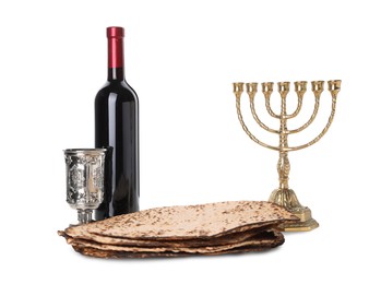 Tasty matzos, wine and menorah on white background. Passover (Pesach) celebration