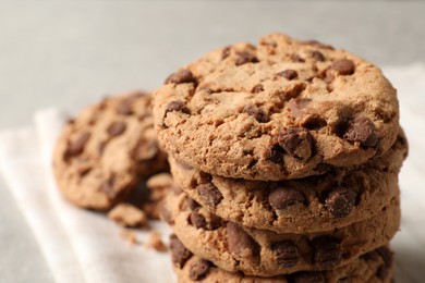 Photo of Delicious chocolate chip cookies on light grey table, closeup