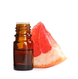 Bottle of citrus essential oil and fresh grapefruit slice on white background