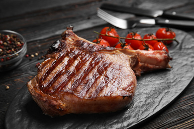 Delicious beef steak served on black wooden table, closeup
