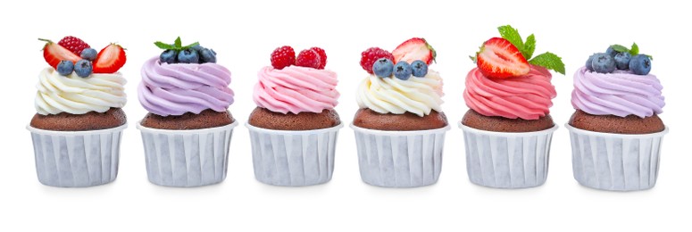 Sweet cupcakes with fresh berries on white background