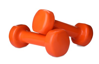 Orange dumbbells on white background. Weight training equipment