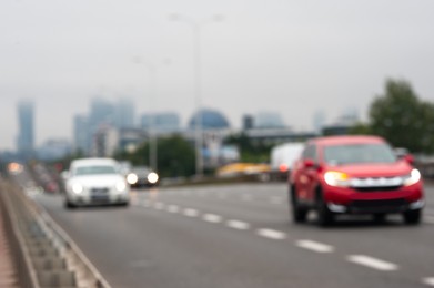 Photo of Blurred view of city road with cars