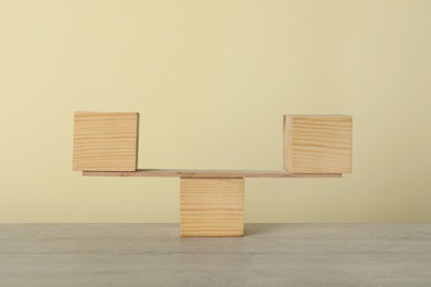 Plank with wooden cubes on table. Harmony and balance concept