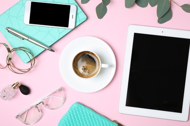 Flat lay composition with tablet, coffee and blogger's stuff on pink background