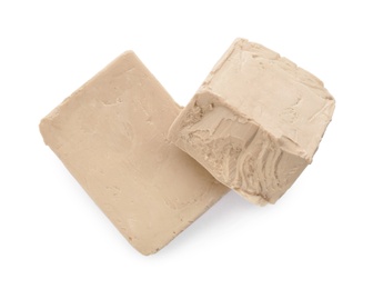 Blocks of compressed yeast on white background, top view