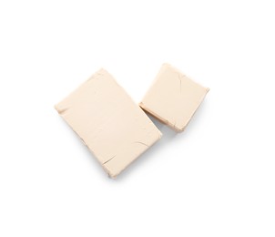 blocks of compressed yeast on white background, top view