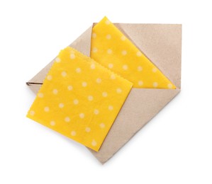 Yellow reusable beeswax food wraps on white background, top view