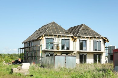 Unfinished house under blue sky in countryside