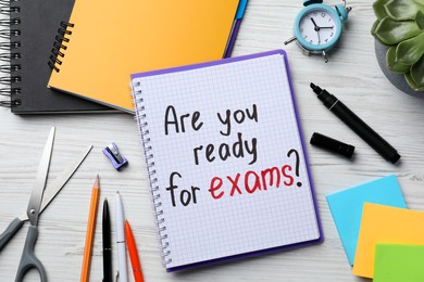 Notebook with question Are You Ready For Exams? on white wooden table, flat lay