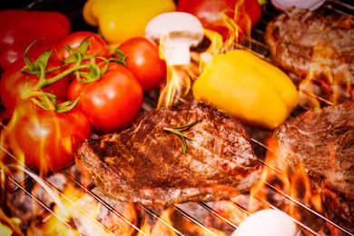 Barbecue grill with food and flame, closeup