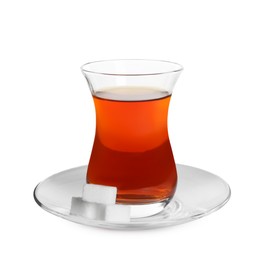 Glass of traditional Turkish tea with sugar cubes isolated on white