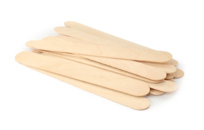 Photo of Disposable wooden spatulas for depilatory wax on white background