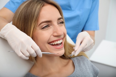 Doctor examining patient's teeth in clinic, closeup. Cosmetic dentistry