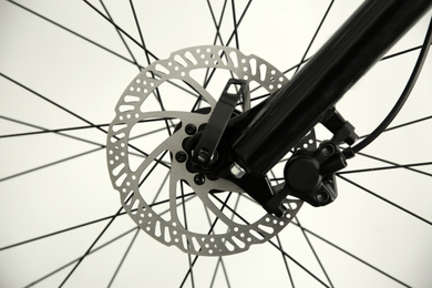 Bicycle wheel on light background, closeup view