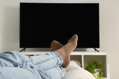 Photo of Woman having rest at stylish TV set, closeup