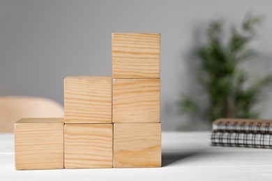 Wooden cubes on white table. Management concept