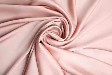 Texture of delicate pink silk as background, top view
