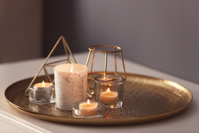 Beautiful burning candles and decor on table at home
