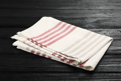 Striped kitchen towel on black wooden table
