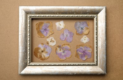 Photo of Beautiful herbarium with pressed dried hydrangea flowers on craft paper, top view