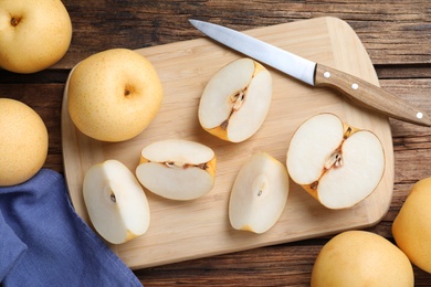 Cut and whole apple pears on wooden table, flat lay