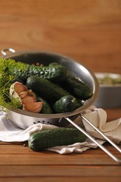 Photo of Fresh cucumbers, dill and garlic on wooden table. Pickling recipe
