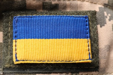 Photo of Ukrainian army patch on military camouflage, closeup