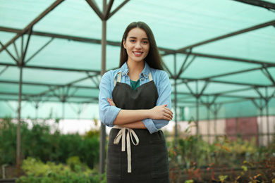 Photo of Young female business owner in her greenhouse