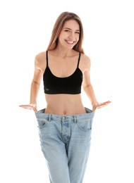 Slim woman in oversized jeans on white background. Perfect body