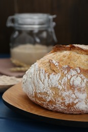 Photo of Freshly baked bread on blue wooden table