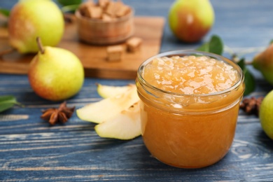 Tasty homemade pear jam and fresh fruits on blue wooden table