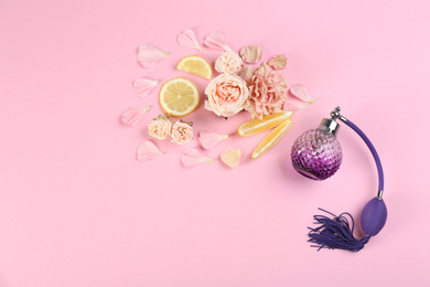 Flat lay composition with bottle of perfume on pink background