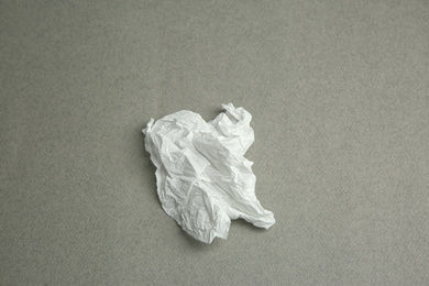 Used paper tissue on grey background, top view