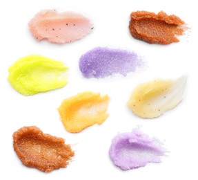 Set with smears of different body scrubs on white background