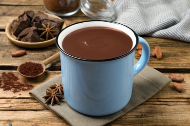 Yummy hot chocolate in mug on wooden table