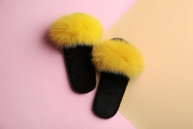 Pair of soft slippers on color background, flat lay