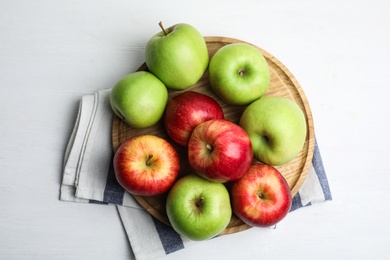 Different sweet apples on white wooden table, top view