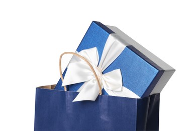 Photo of Blue paper shopping bag with gift box on white background