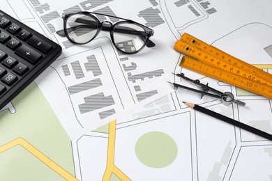 Office stationery on cadastral maps of territory with buildings