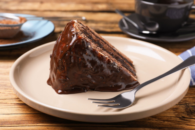 Delicious chocolate cake on wooden table, closeup