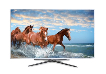 Image of Modern wide screen TV monitor showing horses running near sea, isolated on white