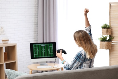 Young woman playing video game at home