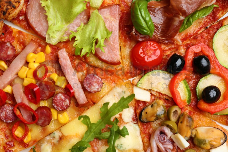 Photo of Slices of different delicious pizzas as background, closeup