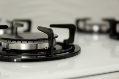 Photo of Modern built-in gas cooktop, closeup with space for text. Kitchen appliance
