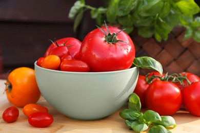 Different sorts of tomatoes on wooden table