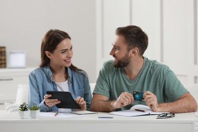 Young couple discussing family budget at home