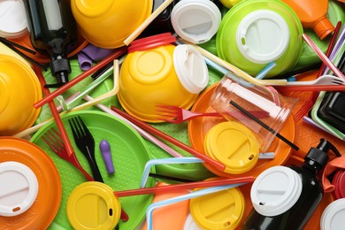 Different colorful plastic items as background, closeup